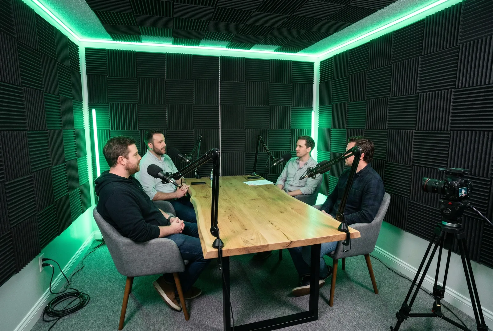 Four guests recording a panel discussion around the studio table