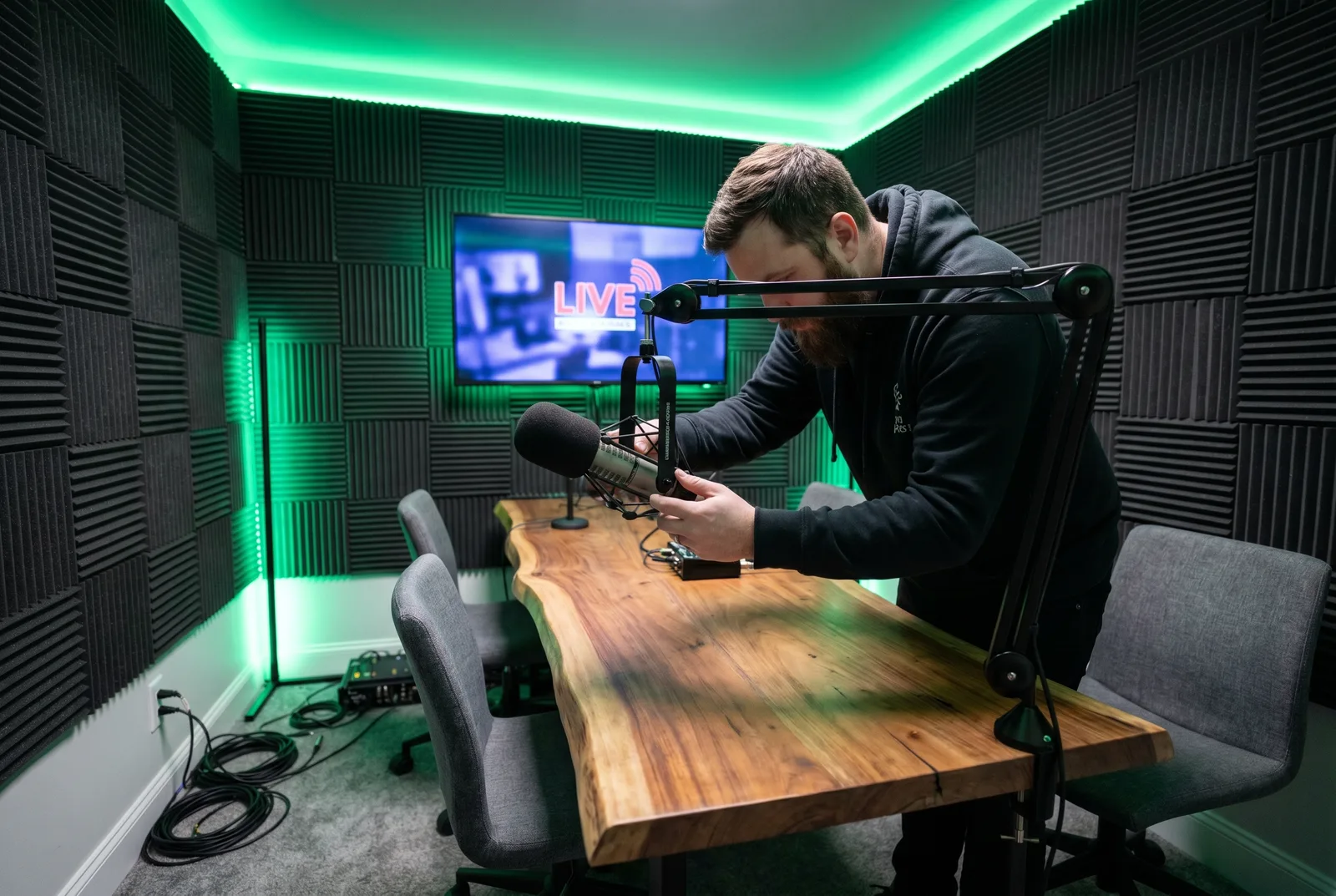 An engineer setting a microphone before a session