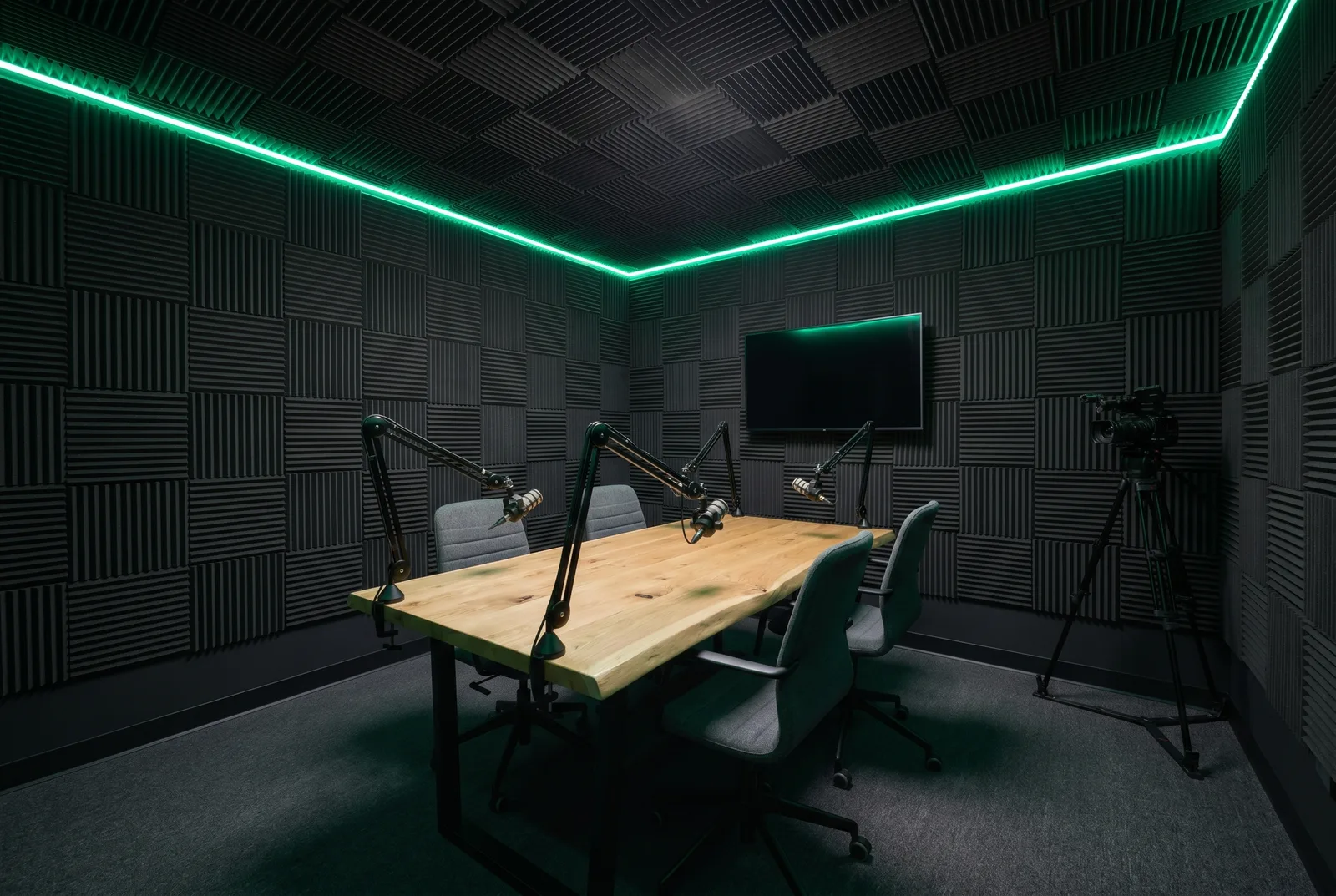 The studio set for a panel: four microphones around the table